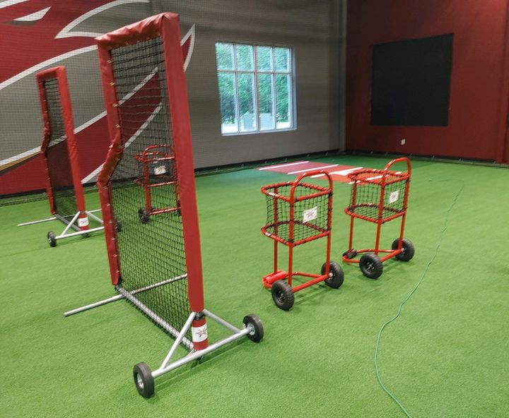 Time to get new ball carts and screens for your cages! Here's a set of ball carts and screens we made for @ElonBaseball to go along with their updated indoor hitting area. 🔗 nettingpros.com/shop/