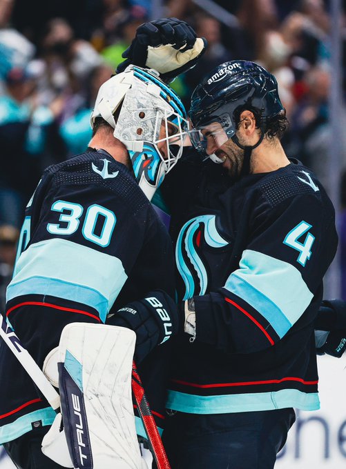 Martin Jones and Justin Schultz hugging after victory