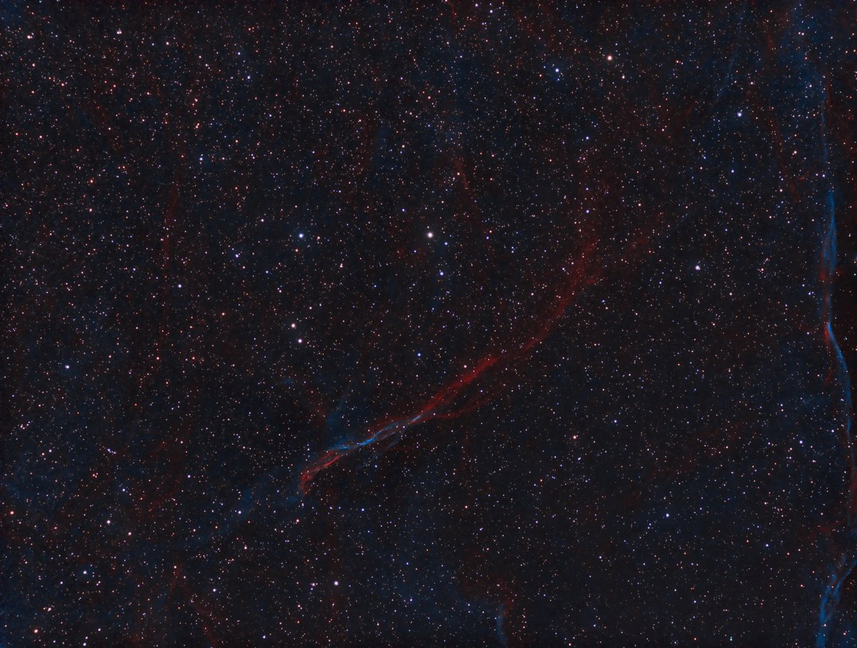 Sh2-94 - Part of a Large Supernova Remnant (2022) Sharpless 94 (Sh2-94) is a part of a very faint supernova remnant (SNR) which includes Sh2-91 and SH2-96. This nebula has quite a bit of oxygen as well as hydrogen which are producing the ropy red and blue strands.