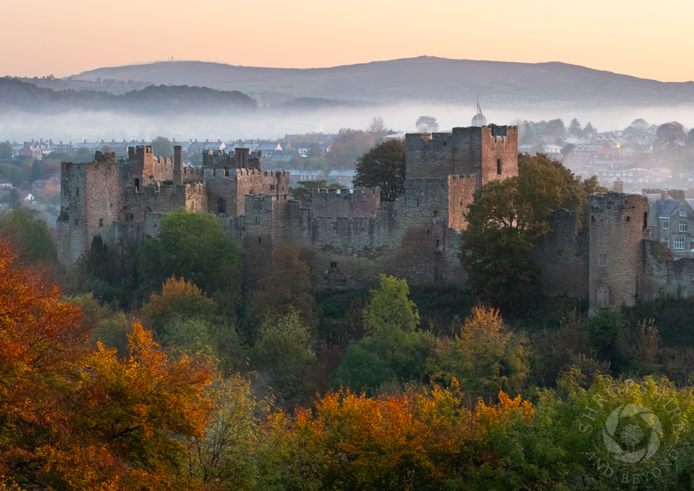 A view for all seasons - #Ludlow Castle at sunrise, surrounded by autumn colour. I took this picture while standing on Whitcliffe Common and watched as swirls of mist encircled the town. Stretching across the horizon is Brown Clee. #Shropshire