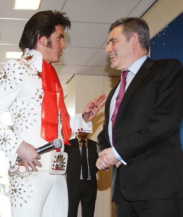 Gordon Brown is joined by an Elvis impersonator on the campaign trail (2010)