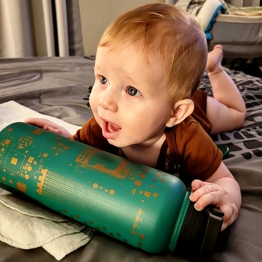 WrenchViking's tweet photo. I know I don't have any control over whether or not Nikolai grows up to be a fellow nerd too, but based on how much he LOVES my @LinusTech  motherboard PCB water bottle, I have high hopes. 😁

He keeps trying to eat it, despite me telling him many times that it's not edible. 😂 https://t.co/DGpx297cLO