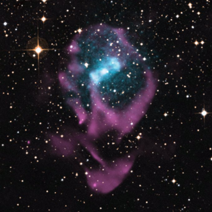 An X-ray binary system totally looks like a skull floating in space with two bright stellar objects floating in a purple cloud shaped like a skull.