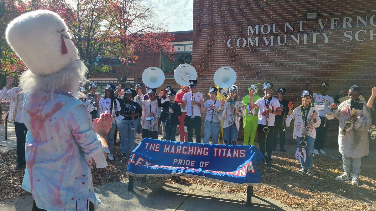 AchsBand's tweet photo. What do zombie bands do before they perform? They re-hearse!!! The ACHS Marching Titan Zombies came out to play! Thanks for including ACHS Marching Band in the Del Ray Halloween Parade today. 
What streets do zombies live on? Dead ends. Tell us your favorite Zombie joke!!! 🤣 https://t.co/2XAye3Kh8G