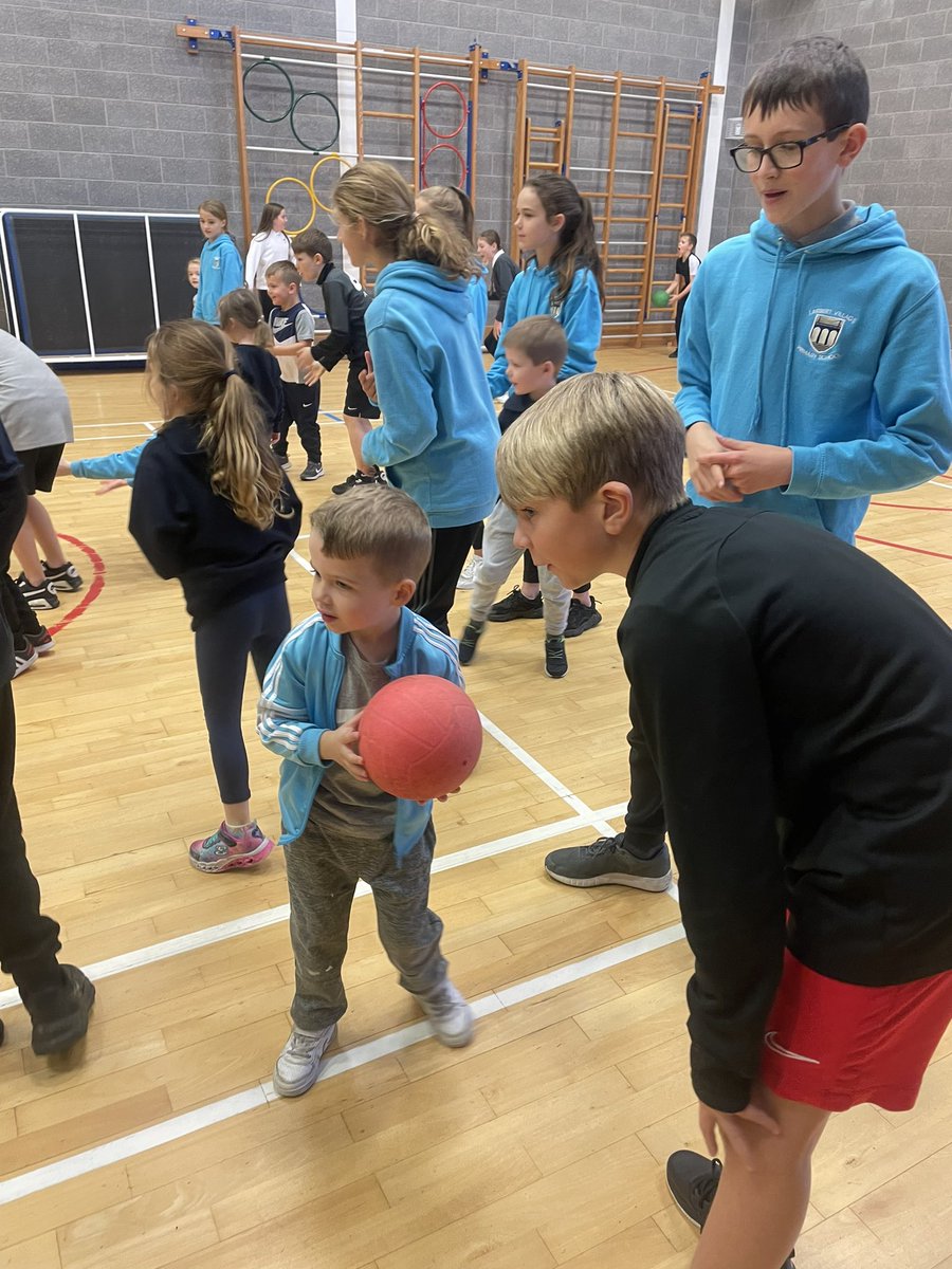 MissTolandADLC's tweet photo. A rainy P.E day can only mean one thing - let’s all play indoors together!👨‍👩‍👧‍👦  P7T were fantastic Sports Leaders today when teaching P1C all about dodgeball! Always so proud of how kind and nurturing our P7 pupils are and how beautifully they model great teamwork! @missmaclvps 💙 https://t.co/8TP2S2H0Ig