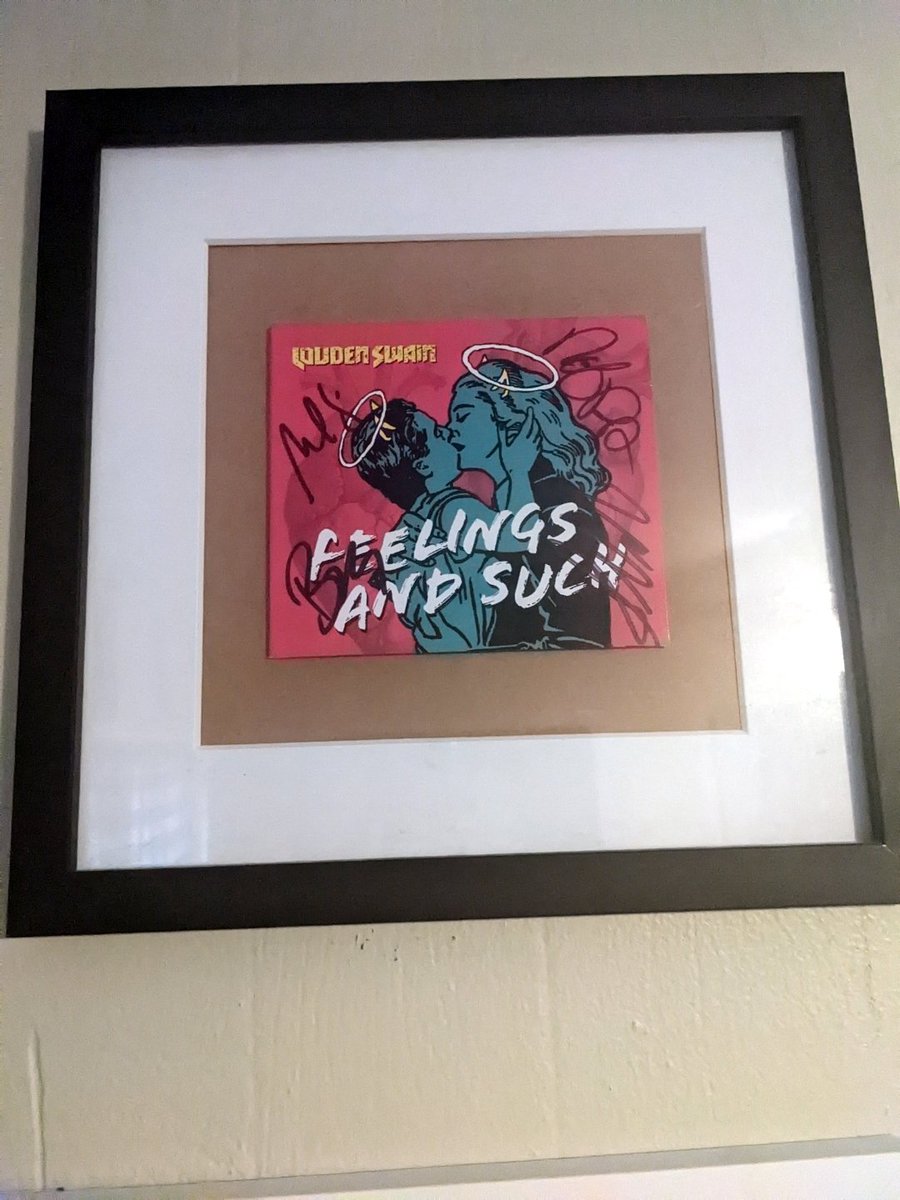 KarylAnneWrites's tweet photo. My signed copy of @LoudenSwain1 's #FeelingsAndSuch makes a great addition to my Swain wall and an even better addition to my speakers. (I had to hurriedly find a frame because my furry little demon Loki thinks anything cardboard is obviously meant to be his snack). https://t.co/zBMcMHho8b