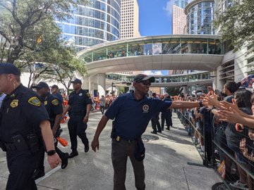 SAC Smith extending his hand and greeting parade goers along the route.