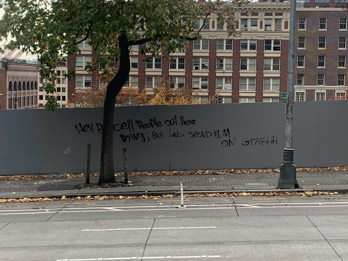 graffiti across from city hall reads: Hey Bruce!! People out here dying, but let’s spend $1M on graffiti