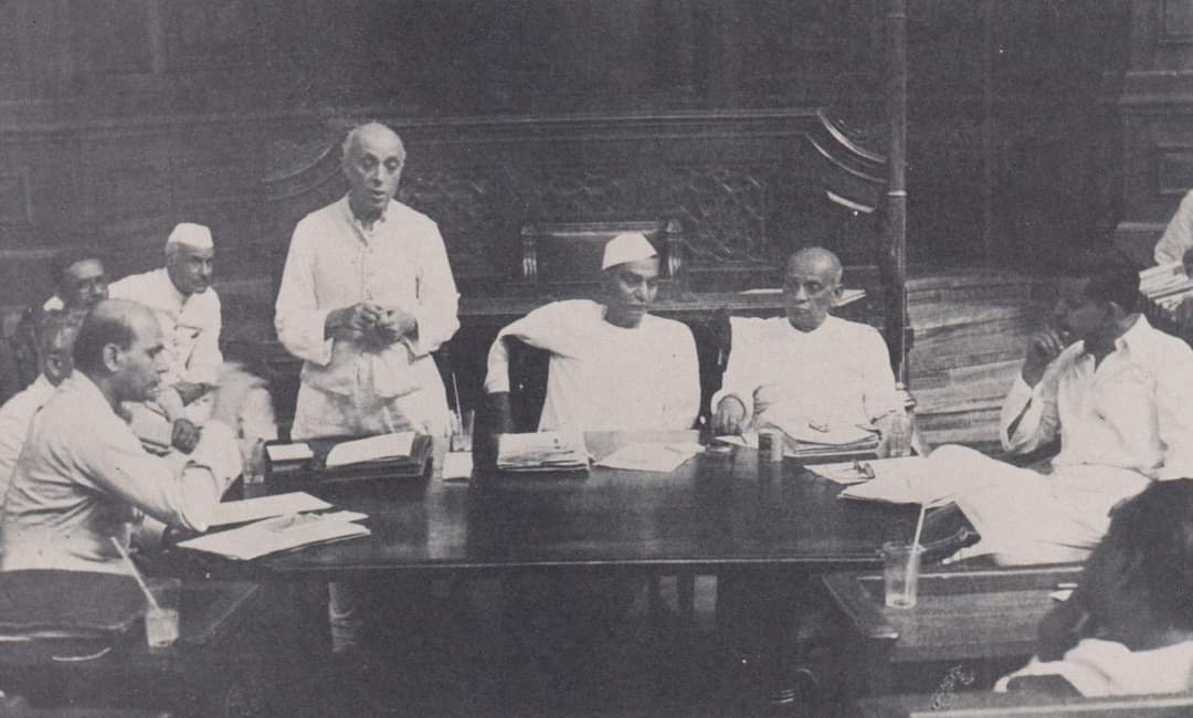 Jawaharlal Nehru addressing a meeting of a committee of the Constituent Assembly , New Delhi , 1949. Rajendra Prasad and Vallabhbhai Patel are seated at right.