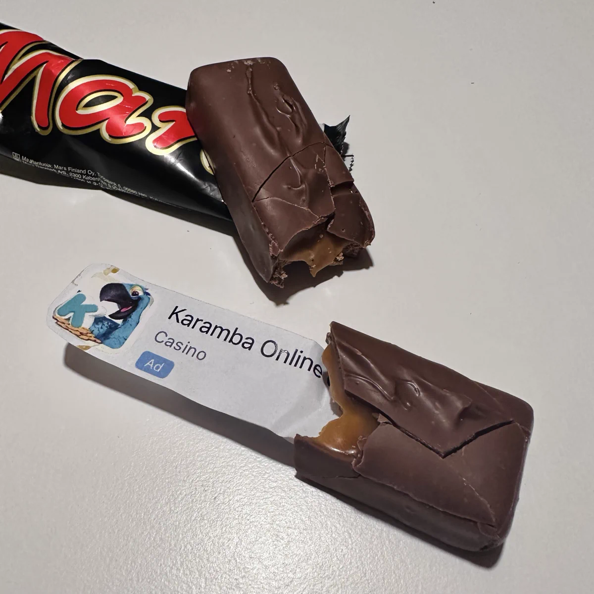 A chocolate bar with an ad for a gambling app inside.
