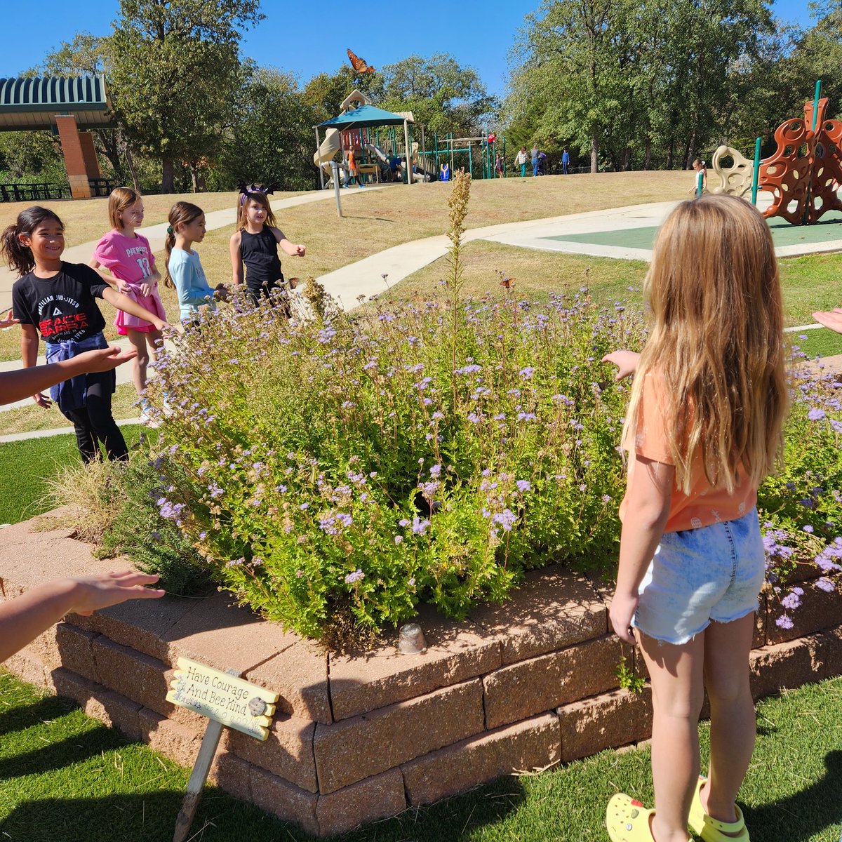 Butterflies 🦋  at recess! Trying to stand still so they will land on us for good luck!