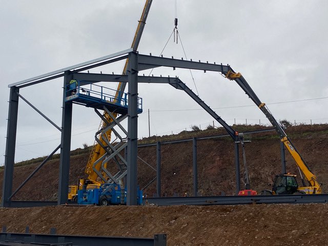 An exciting day (outside) the distillery today as the first steel beams of our new warehouse are erected. #Islay