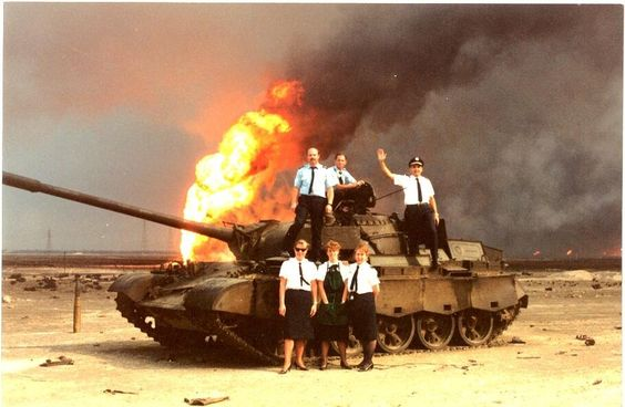 Crew of a Pan-Am 747 chartered for transporting US Troops pose with an Iraqi Tank. 1990.