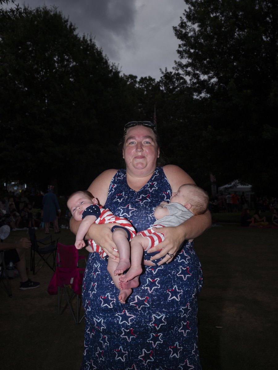 Felicia Boartfield holding her children Johan Boartfield, left, and Anthony Boartfield at a community Independence Day celebration in downtown Commerce, Georgia earlier this year for The New York Times.