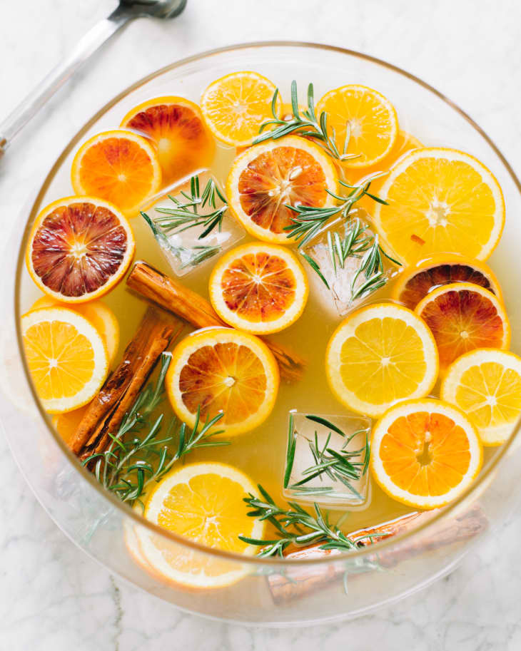 thekitchn's tweet photo. Say hello to your new favorite holiday tradition. This refreshing sangria, made with white wine, vodka, freshly squeezed orange juice, and triple sec, is topped with sliced citrus, cinnamon sticks, and fresh rosemary for a party-worthy presentation: https://t.co/7uNI65LNZN https://t.co/yhmFyo8LBs