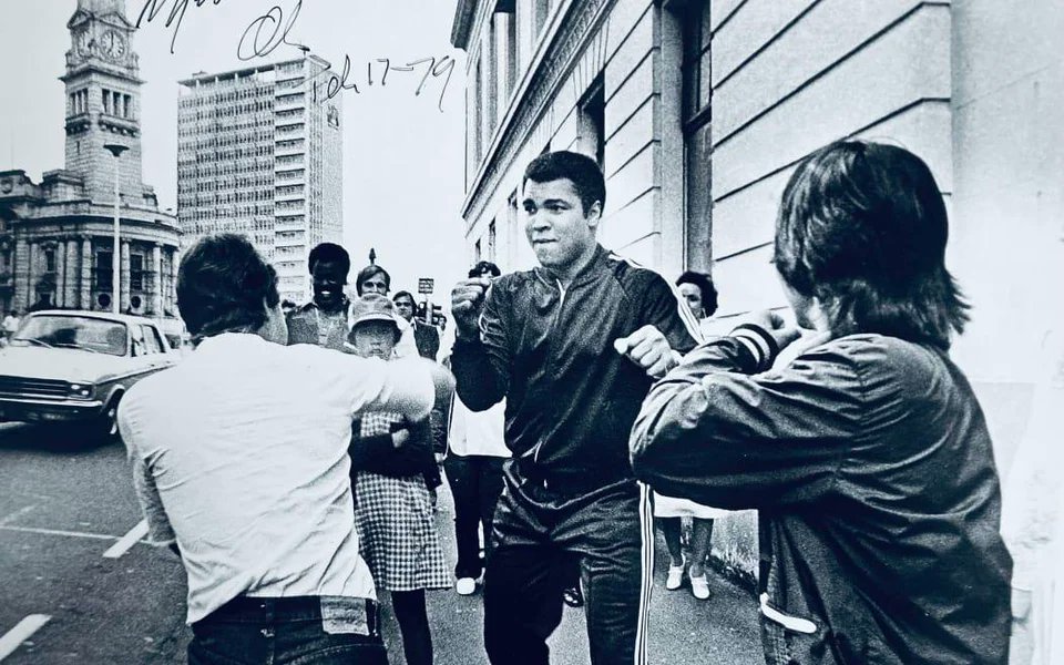 Muhammad Ali sparring with two teenagers during a promotional tour of New Zealand, 1979