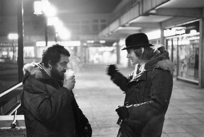 Stanley Kubrick and Malcolm McDowell take a break on the set of, A Clockwork Orange (1971).