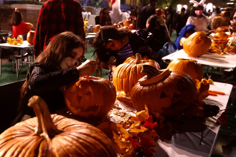 People celebrate Halloween with traditional parades, pumpkin carvings