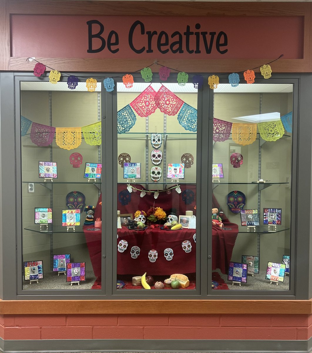 Students that celebrate Dia de los Muertos brought in items and created an offenda to educate their peers on the traditions of Day of the Dead. I then decorated the rest of the display with Day of the Dead artwork created by Mrs. Delgado and Ms.  Ramirez’s students. <a href="/d56achieve/">D56Achieve</a>