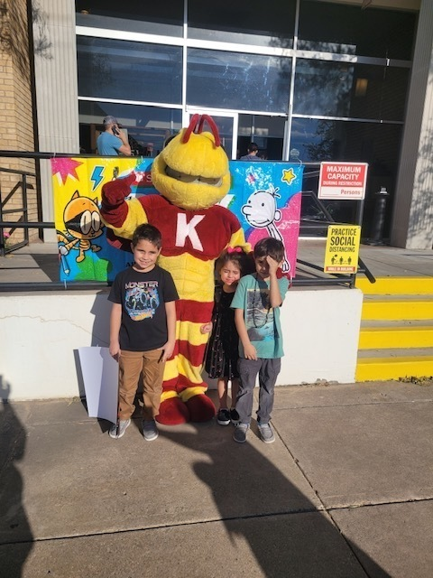 Kermit High School Mascot participating in the book fair at Kermit Elementary.