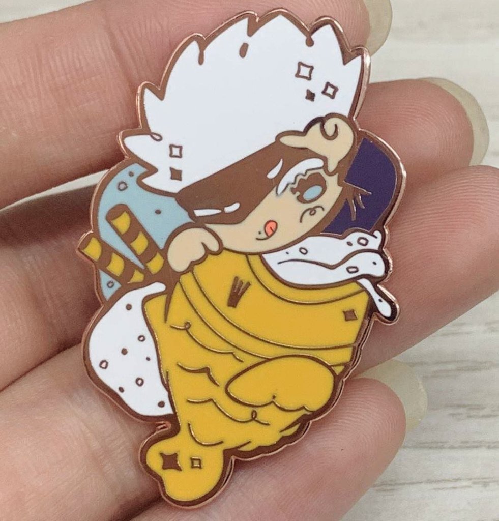We've also gotten a photo directly from our manu! Here's how the Taiyaki Gojou pin by <a href="/jeqrow/">Qrow</a> turned out 🥰✨ 

The pins are currently the last merch item we're waiting on (besides the main book) and will be shipped to us very soon. We'll be taking better photos once they arrive!
