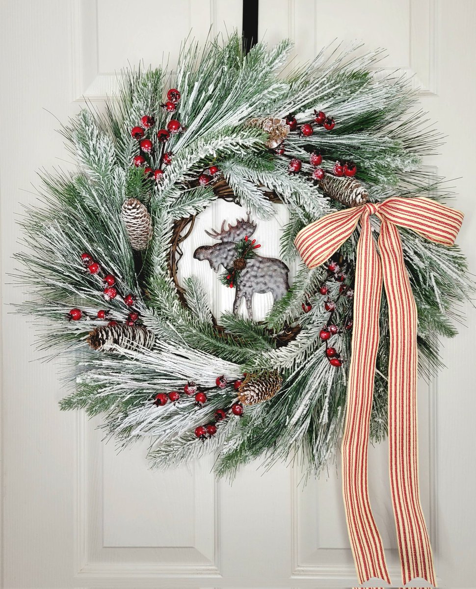 Old fashioned rustic Christmas cabin wreath with flocked pine, pinecones, frosted berries, moose and option of red and white ticking bow. #handmade #etsyshop #christmasdecor #handmadewreaths #farmhousewreath #holidaydecor