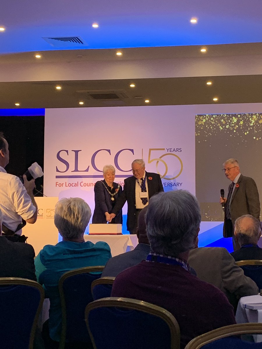 Adrian Corder-Birch &amp; President Linda Carter cut the birthday cake. Adrian is still an Essex clerk, starting at aged 17. He was present at the formation meeting of <a href="/SLCCnews/">SLCC</a> in 1972 as was Margaret Grimster, another Essex SLCC member (previous clerk) #slccnational