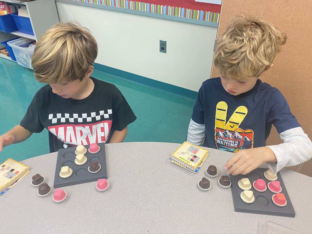 CReillyRTG's tweet photo. Lots of thinking about attributes and geometry with second grade. Triple Venn Diagrams, building 3D structures out of cubes/counting exposed faces, and my favorite brain numbing  game Chocolate Fix! @TuckahoeSchool https://t.co/Xy9S4MdF2x