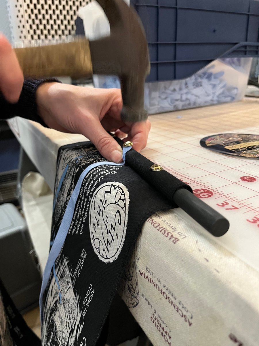 Hammering in the final golden nail to pin the ribbon to a River Scroll #cityofwinter