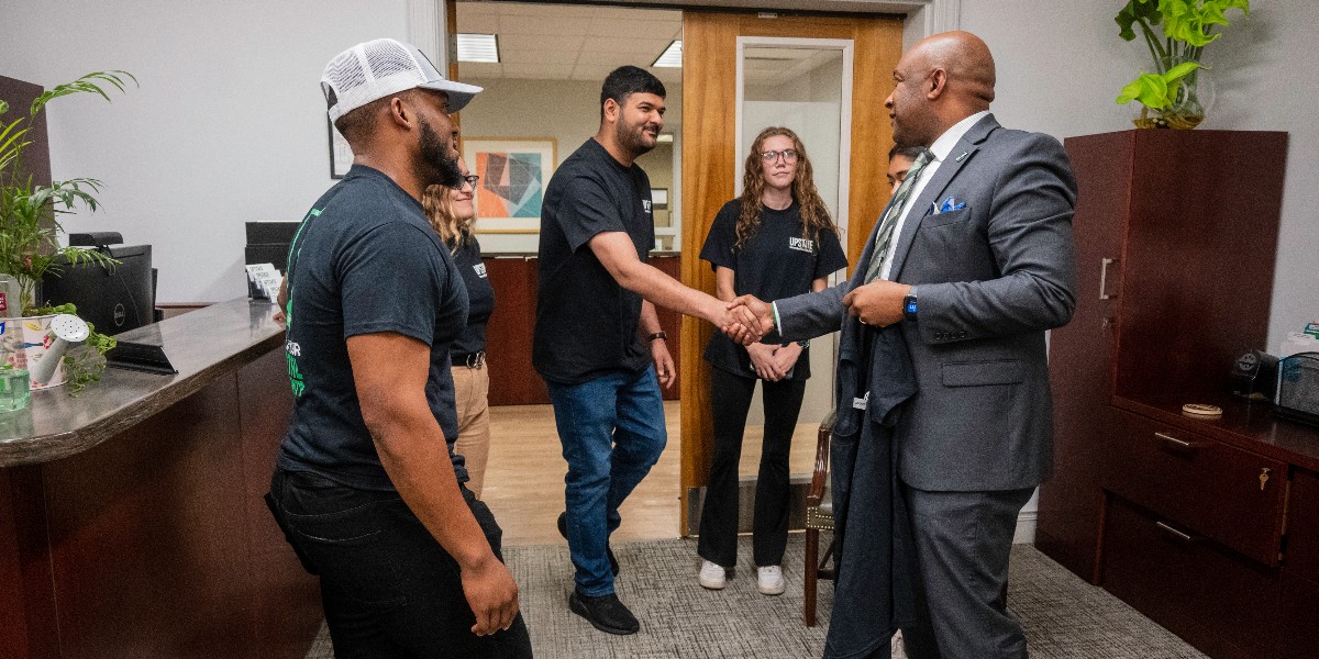 USCUpstate's tweet photo. Some of our talented Cybersecurity students stopped by Chancellor Harris' office to gift him one of their new "What is Your Digital Footprint" T-shirts, designed by Studio Upstate. We are so excited that soon we will graduate our first student from this tough program. Stay tuned! https://t.co/YhYtXnuEHV