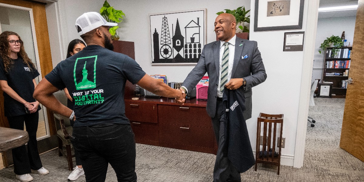 USCUpstate's tweet photo. Some of our talented Cybersecurity students stopped by Chancellor Harris' office to gift him one of their new "What is Your Digital Footprint" T-shirts, designed by Studio Upstate. We are so excited that soon we will graduate our first student from this tough program. Stay tuned! https://t.co/YhYtXnuEHV