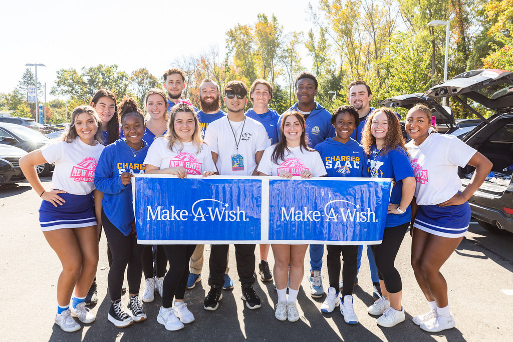 NCAA's tweet photo. The @UNHChargers Student-Athlete Advisory Committee brought Anthony’s wish of having a pool to life with a pool party-themed wish reveal at a recent football game.
 
@NCAADII has been a @MakeAWish partner since 2003, granting more than 760 wishes.💫

#MakeItYours x @MakeAWishCT https://t.co/2rlEYTnsa5