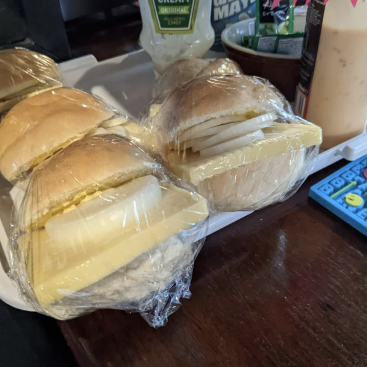 beardedjourno's tweet photo. A pub's cheese rolls have gone viral thanks to the much-shared photo on the left. I did some hard-hitting investigative journalism and tracked down the Bristol pub landlord who is the man behind these mythical baps: https://t.co/iQeEkKqA18 https://t.co/V522ckxeov