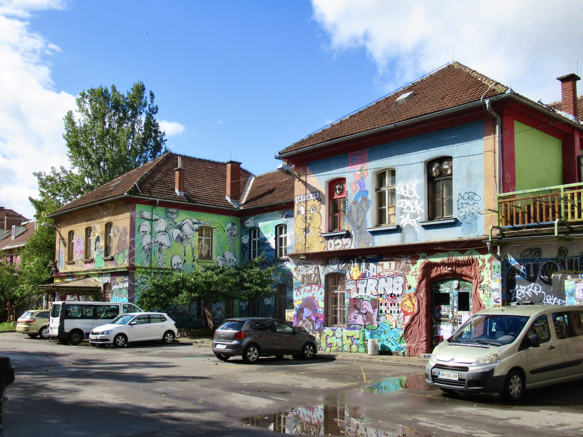 ChrisJSharm's tweet photo. The bus arrived in #Ljubljana at 3:00am. 😴 I was staying at a hostel in #Metelkova, which was a five minute walk from the station. Under cover of darkness I couldn’t see how eccentric the area was. In the morning I got such a surprise when I saw the buildings. 😍 https://t.co/VA4P8K3Dty