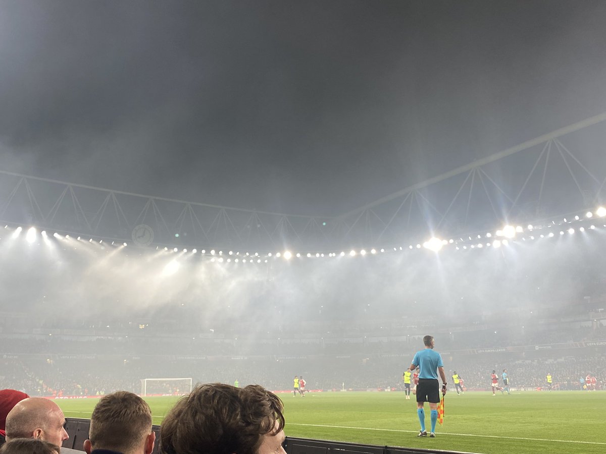 cinderemma10's tweet photo. Smoky night under the lights thanks to the flare &amp; firecracker display from Zurich. That away end was very lively! Another @arsenal win! #ARSZUR https://t.co/1bHrPOx530