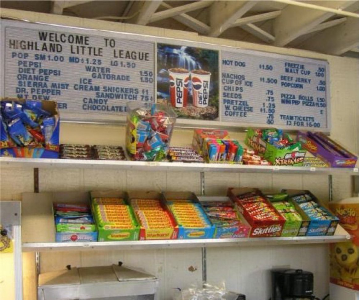 Super70sSports's tweet photo. Nothing better than a Little League concession stand. Your five dollars still goes farther there than just about anywhere else plus you get the added bonus of parents awkwardly serving their involuntarily “voluntary” community duty. Pure Americana. https://t.co/7BWZXAoKF0