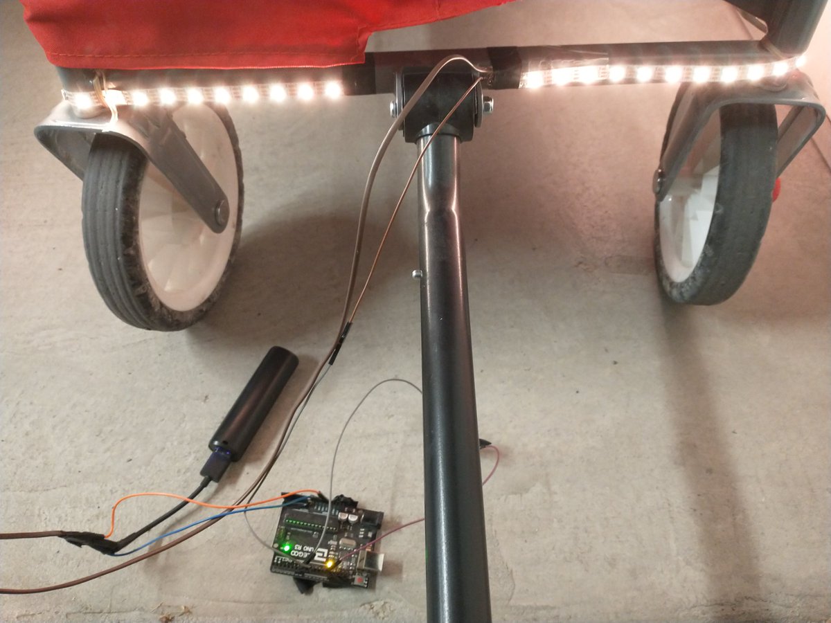 thinklearndo1's tweet photo. Here's my lit up wagon I hacked together for taking the kids trick or treating. I originally was going with a solid orange for halloween, but the kids liked the scrolling rainbow better! Used an #Arduino powered off a usb battery pack. https://t.co/NmI9rImar3