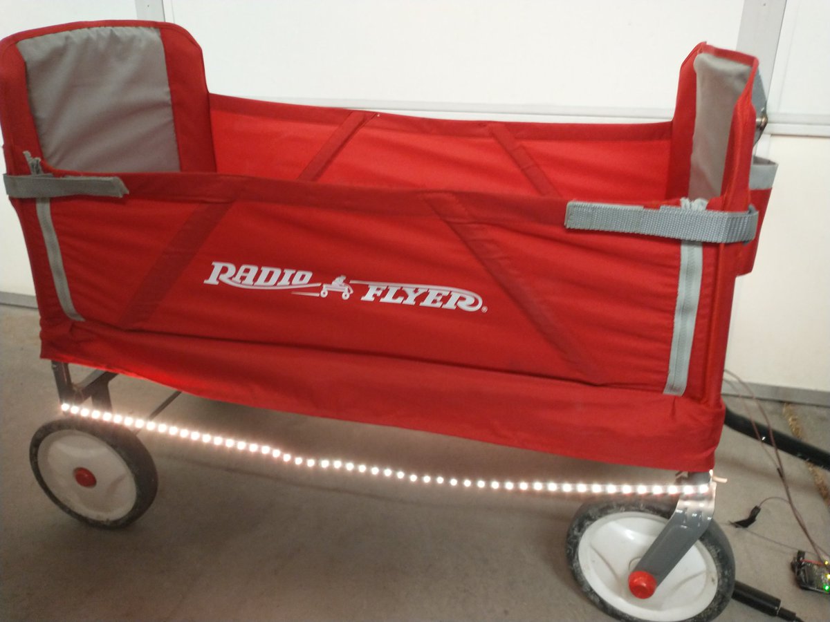 thinklearndo1's tweet photo. Here's my lit up wagon I hacked together for taking the kids trick or treating. I originally was going with a solid orange for halloween, but the kids liked the scrolling rainbow better! Used an #Arduino powered off a usb battery pack. https://t.co/NmI9rImar3