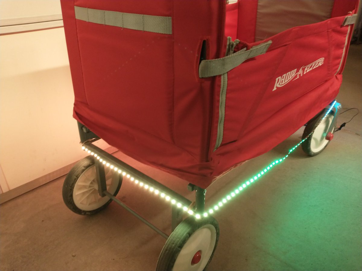 thinklearndo1's tweet photo. Here's my lit up wagon I hacked together for taking the kids trick or treating. I originally was going with a solid orange for halloween, but the kids liked the scrolling rainbow better! Used an #Arduino powered off a usb battery pack. https://t.co/NmI9rImar3