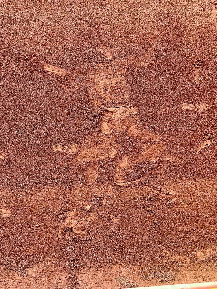 After Chas McCormick made 'The Catch' he fell back onto the warning track. One of Traces of Texas reader Lorri White's friends was sitting right there and snapped this photo of the impression Mccormick's body made in the dirt there and sent it to Lorri seconds afterward. Awesome!