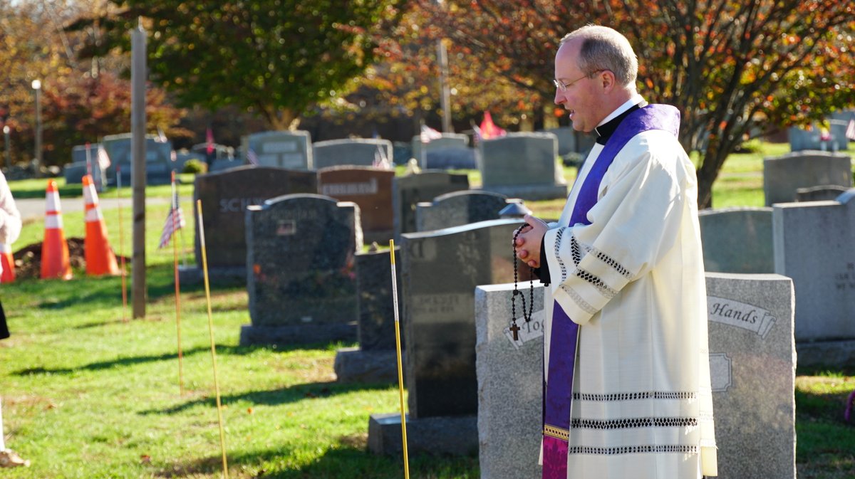 Fr. Marcello led the middle school students at St. Catherine of Siena School in praying the Sorrowful Mysteries of the Rosary on Thursday on a walk through the Nichols Village Cemetery to pray for the faithful departed of the parish.