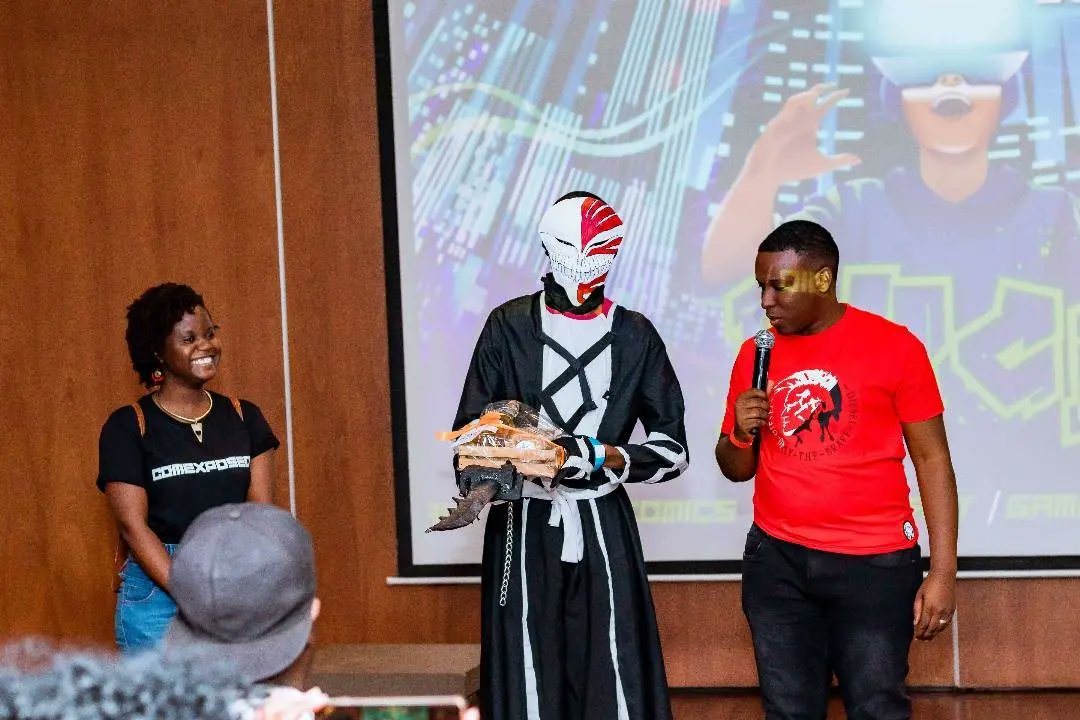 Comexposed's tweet photo. Slide 1: @Eugene_Ramirez with @simbirirai and @MusekiwaSamu and Kalai Barlow during the talks segment.  
Slide 2: the audience engaging in a Q&amp;A during the talks 
Slide 3: Electric musicial performances by VI The Law 
Slide 4: @OfficialMutupo wins best cosplayer
#comexposed https://t.co/BjcOMHlhYs