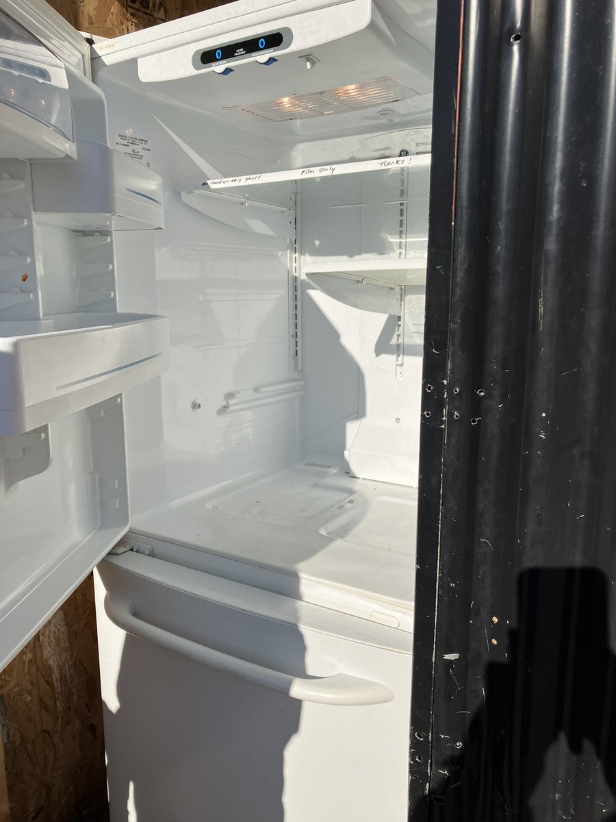Jocmartel's tweet photo. Community fridge - empty. And shelves are sparse. Winter is near.  Resource bins are close to empty everywhere. Please give generously. https://t.co/SlUT16aoqG