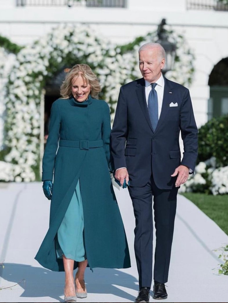 Today for Naomi Biden's wedding, @FLOTUS wore a custom couture @Reem_Acra silk chiffon vintage blue dress with draping details along with a teal double face wool crepe coat, according to the designer.