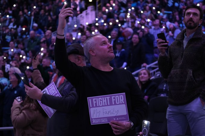 Photo of a fan holding up an I Fight For sign