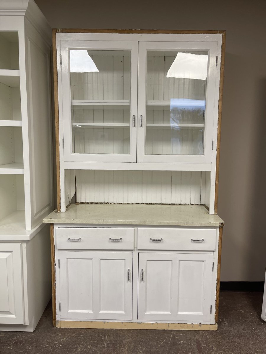 BuildingValue's tweet image. Vintage Mission-style step-back cupboard hutch. This hutch is constructed out of solid wood with a beadboard back and is painted white. Large shelf area with glass doors, open counter area, a base with 2 drawers and 2 doors. This piece measures 48” wide x 85” tall x 20” deep.