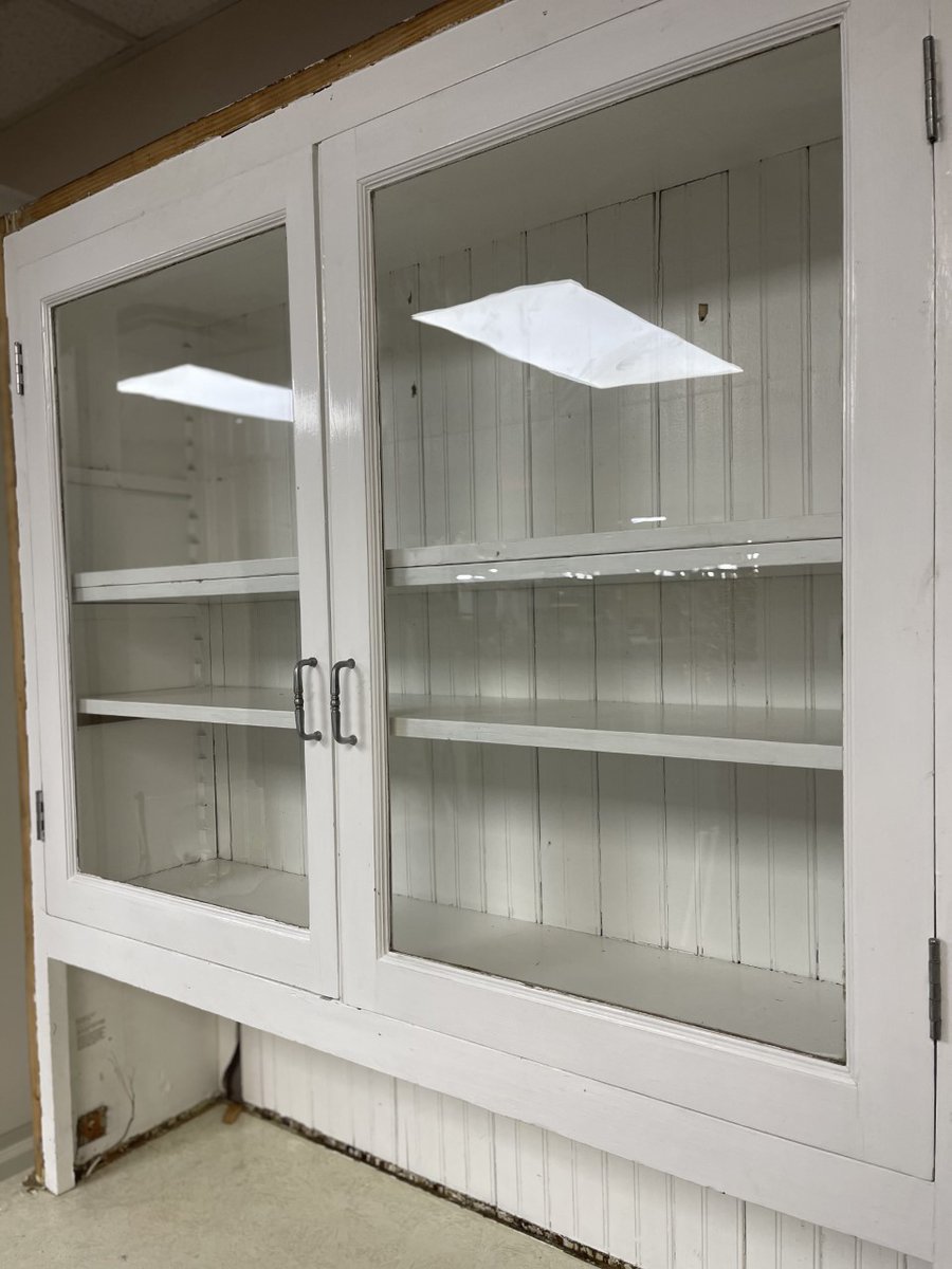 BuildingValue's tweet image. Vintage Mission-style step-back cupboard hutch. This hutch is constructed out of solid wood with a beadboard back and is painted white. Large shelf area with glass doors, open counter area, a base with 2 drawers and 2 doors. This piece measures 48” wide x 85” tall x 20” deep.