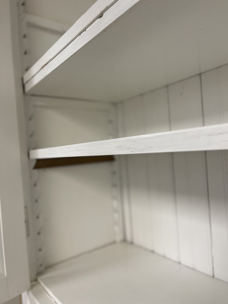 BuildingValue's tweet image. Vintage Mission-style step-back cupboard hutch. This hutch is constructed out of solid wood with a beadboard back and is painted white. Large shelf area with glass doors, open counter area, a base with 2 drawers and 2 doors. This piece measures 48” wide x 85” tall x 20” deep.