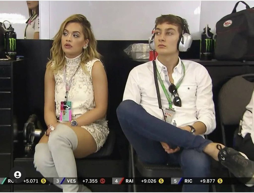 This pic of George sitting next to Rita Ora in the Mercedes garage will never not be funny to me