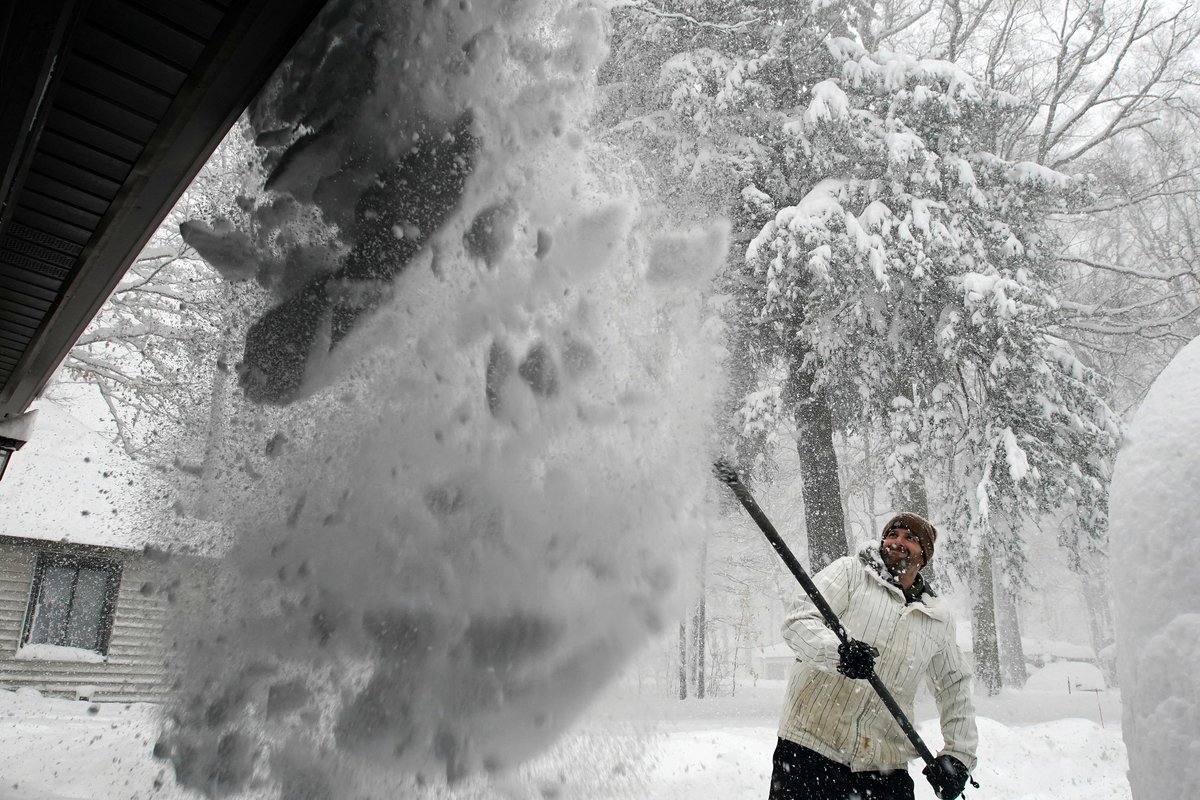 Ben Wilson clears his roof of nearly 2 feet of snow at his home in Orchard Park Friday, November 18, 2022.      (Mark Mulville/Buffalo News) #buffalosnow